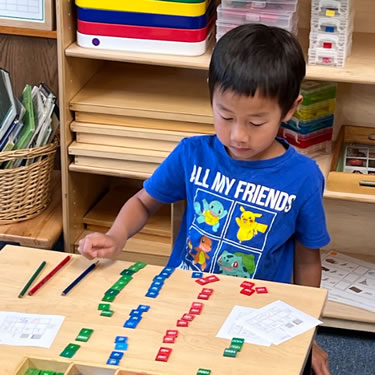 Child playing with math toys