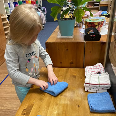 Child playing with fabric